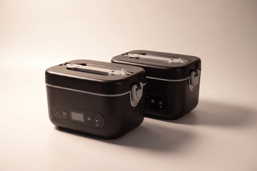 Two heated lunch boxes, side by side